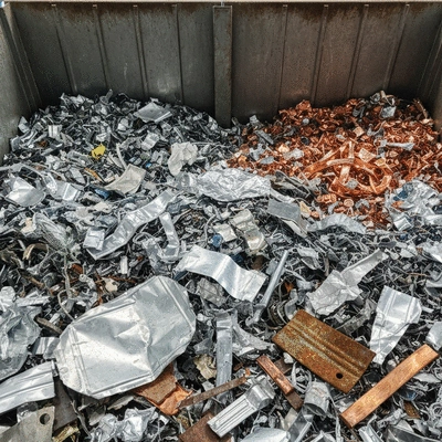 Close-up of various sorted scrap metals (aluminum, copper, steel) in recycling facility, clean image